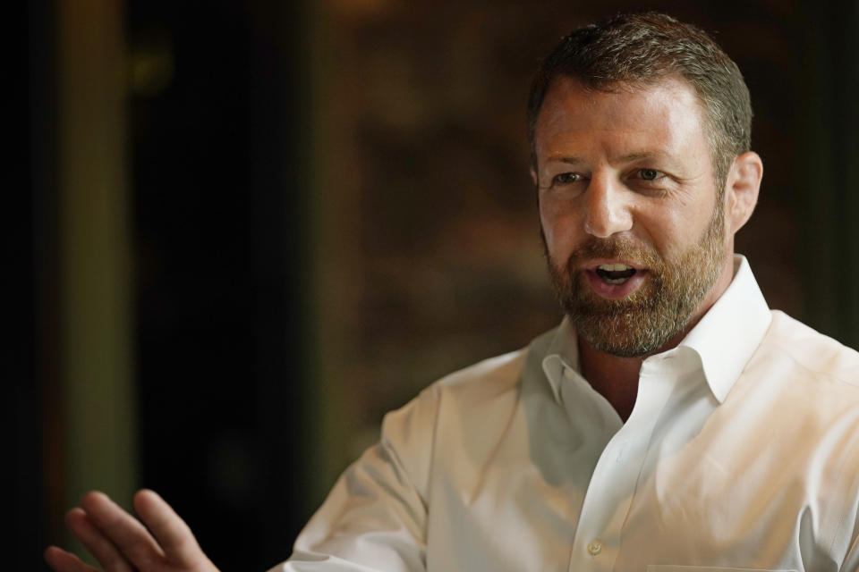 U.S. Rep. Markwayne Mullin, candidate in the Oklahoma Republican Primary runoff election for U.S. Senate, speaks with supporters Tuesday, Aug. 23, 2022, at a luncheon in Norman, Okla. (AP Photo/Sue Ogrocki)