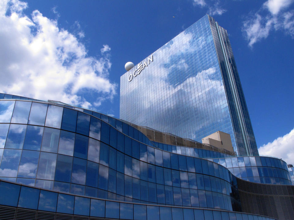 This May 15, 2019 photo shows clouds reflected in the glass exterior of the Ocean Casino Resort in Atlantic City N.J. The Ocean and Hard Rock casinos both reopened on June 27, 2018, and are fighting for business in the expanded Atlantic City gambling market. (AP Photo/Wayne Parry)