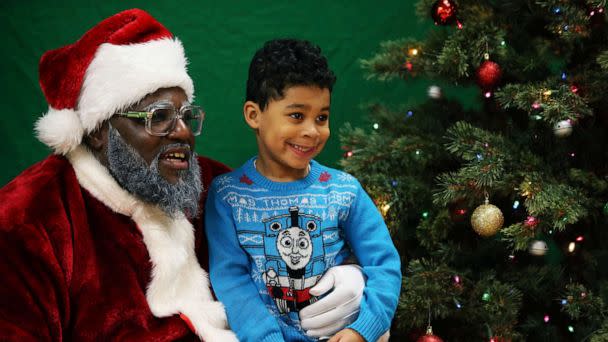 PHOTO: In this Dec. 16, 2018, file photo, a child sits on Santa's lap at the Langston Hughes Performing Arts Institute in Seattle. (Genna Martin/San Francisco Chronicle via AP, FILE)