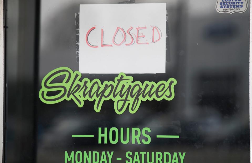A closed sign is posted on the door of Skraptyques, located in the Holly Center shopping plaza in Lumberton, on Wednesday, April 13, 2022.  