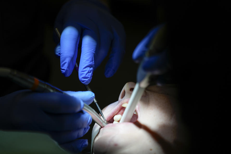 Danielle Wilkes is seen by a dentist during a clinic visit Thursday, Sept. 7, 2023, in Nashville, Tenn. Wilkes waited five years to have her teeth repaired after getting several teeth knocked out in a car wreck. She was able to receive dental care after an expansion of the state's Medicaid program. (AP Photo/George Walker IV)