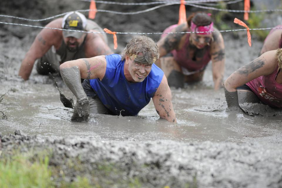 This Saturday, April 27, 2013 photo provided by Nuvision Action Image LLC shows a contestant in The Mud Monster competing during The Survival Race in Dallas. (AP Photo/Nuvision Action Image LLC, J. Dennis Thomas)
