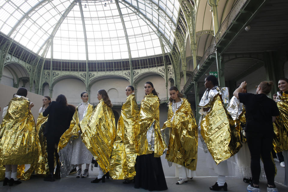 FILE - In this Jan. 21, 2020 file photo, models wait before the presentation of Chanel Haute Couture Spring/Summer 2020 fashion collection, in Paris. The coronavirus pandemic has instilled extra unpredictability into the already fickle Paris Fashion Week. After first canceling the July shows for menswear and Haute Couture, the French fashion federation has now organized an unprecedented schedule of digital-only events instead. (AP Photo/Thibault Camus, File)