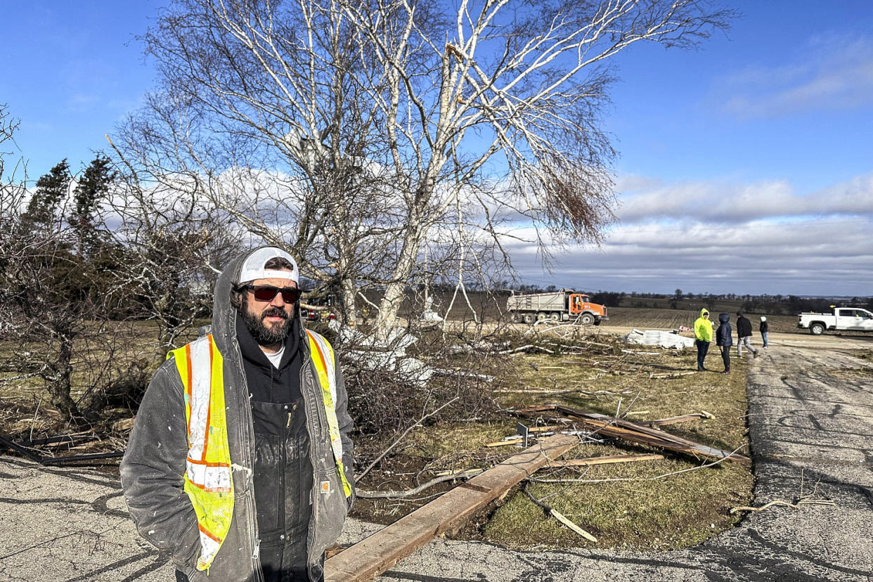 Image: Andy Wagner, 40, surveys the damage on Feb. 9, 2024, outside his parents' home in the Town of Porter, Wis., (Todd Richmond / AP)