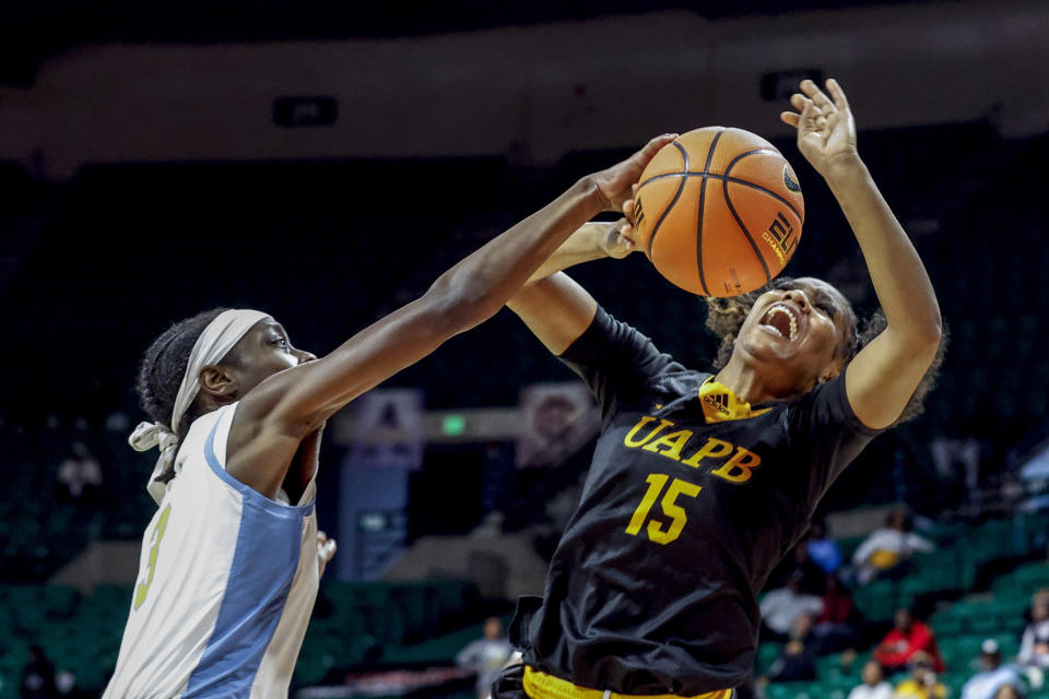 Arkansas-Pine Bluff guard Coriah Beck (15) is fouled by Southern guard Taylor Williams (3) as she puts up a shot during the second half of an NCAA college basketball game in the championship of the Southwestern Athletic Conference Tournament, Saturday, March 11, 2023, in Birmingham, Ala. (AP Photo/Butch Dill)