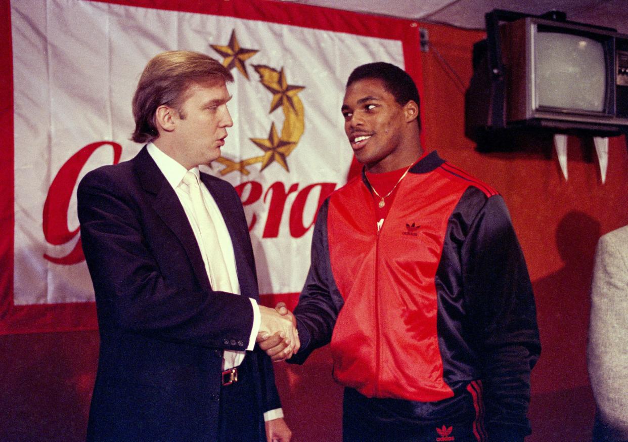 New Jersey Generals owner Donald Trump, left, shakes hands with Herschel Walker at a news conference in New York, after agreeing on a four-year contract on March 8, 1984.