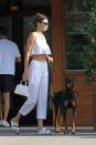 <p>The model was spotted with her dobermann Six, heading for dinner in Malibu with friends on August 2nd. Wearing a mask, and an all-white outfit in the form of linen trousers, a peplum crop top and Birkenstocks, the model looked both chic and Covid-safe.</p>
