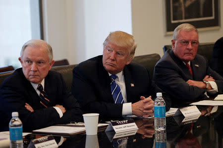 Republican presidential nominee Donald Trump sits with U.S. Senator Jeff Sessions (R-AL) (L) and retired U.S. Army General Keith Kellogg (R) during a national security meeting with advisors at Trump Tower in Manhattan, New York, U.S., October 7, 2016. REUTERS/Mike Segar