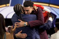 Chris Duarte, right, hugs supporters after being selected as the 13th overall pick by the Indiana Pacers during the NBA basketball draft, Thursday, July 29, 2021, in New York. (AP Photo/Corey Sipkin)