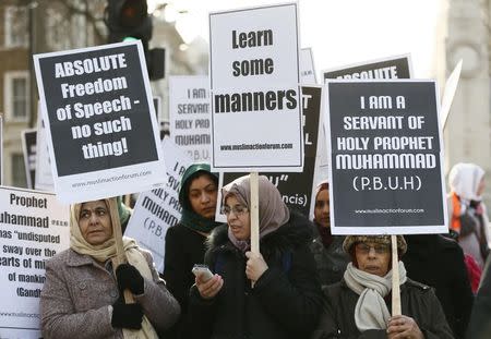 Muslim demonstrators hold placards during a protest against the publication of cartoons depicting the Prophet Mohammad in French satirical weekly Charlie Hebdo, near Downing Street in central London February 8, 2015. REUTERS/Stefan Wermuth