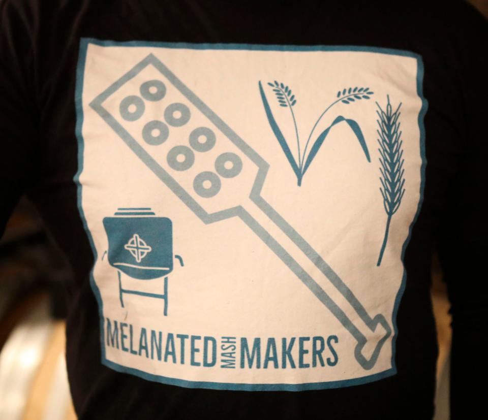 A member of the Melanated Mash Makers wears the group's logo on a shirt.