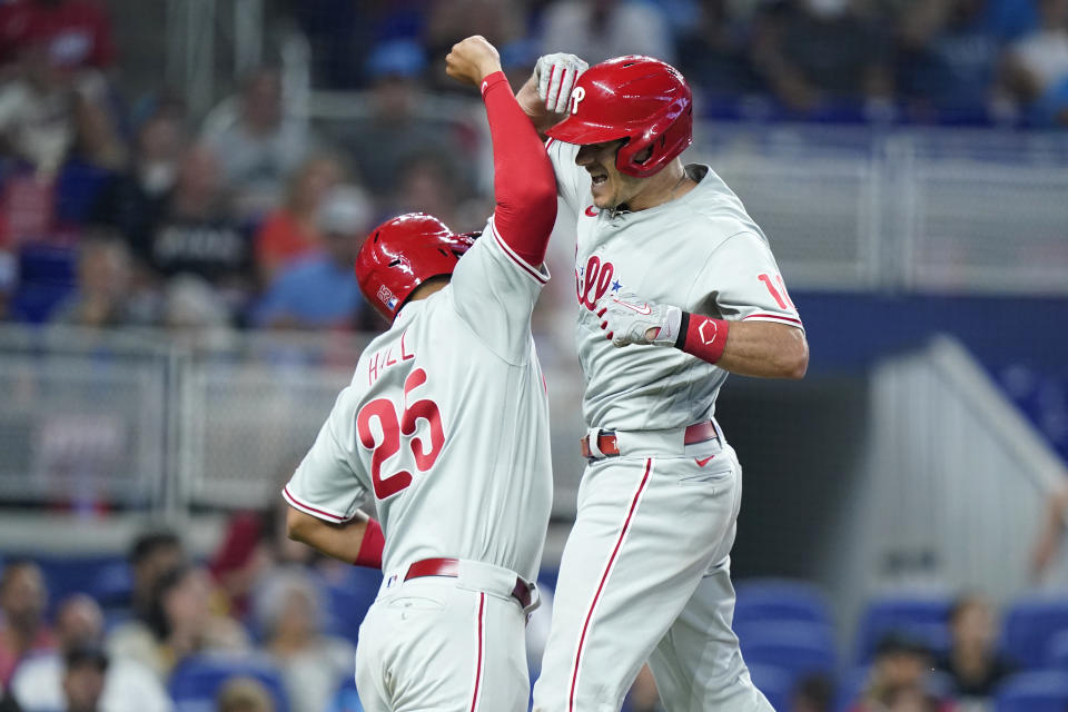 Philadelphia Phillies' J. T, Realmuto, right, celebrates with Darick Hall (25) after scoring on a two-run home run during the fourth inning of a baseball game against the Miami Marlins, Saturday, July 16, 2022, in Miami. (AP Photo/Lynne Sladky)