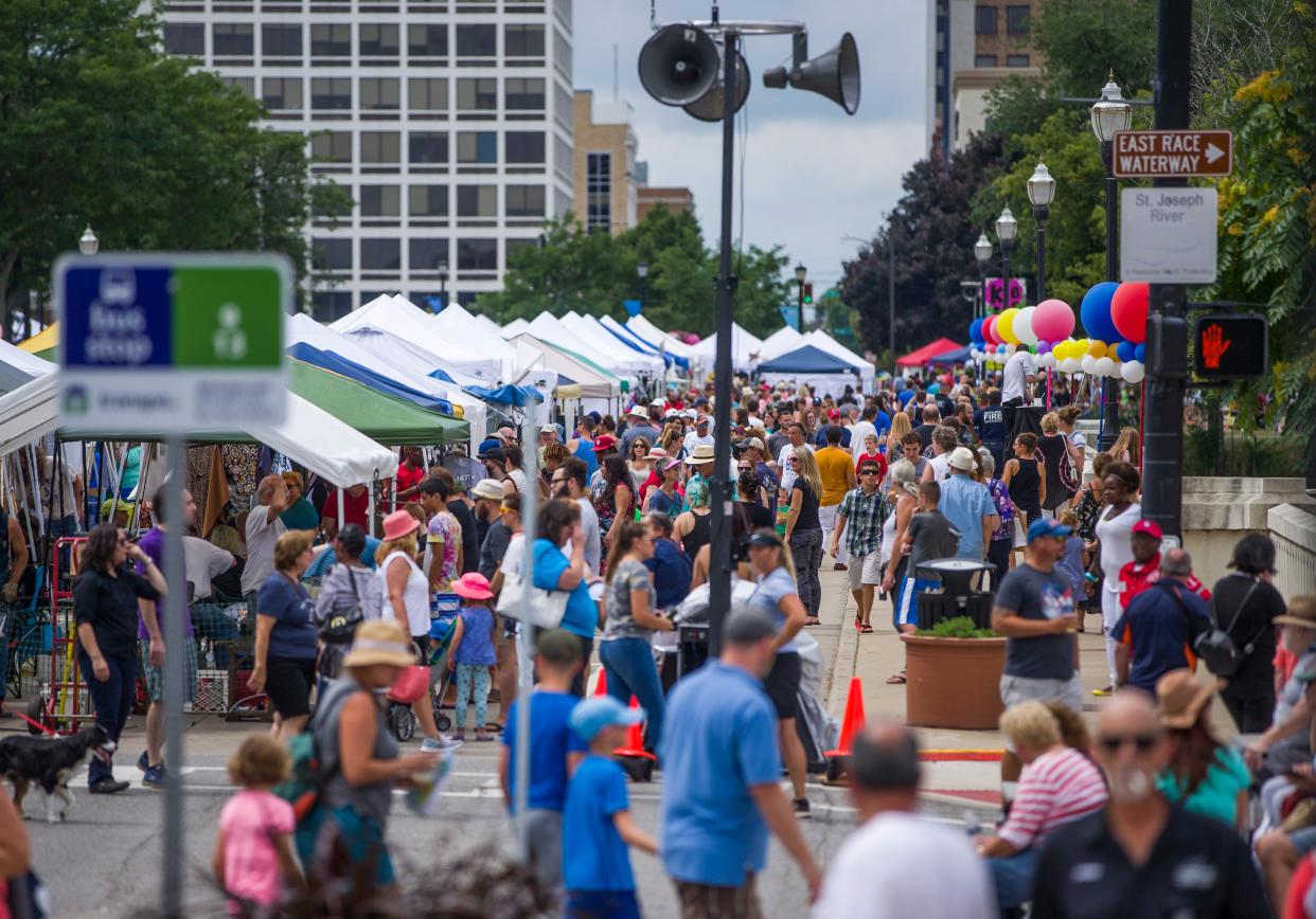 In this file photo, large crowds and booths fill the streets during Art Beat on Saturday, Aug. 17, 2019, in South Bend. Downtown South Bend Inc. is now accepting applications from visual, performing and culinary artists to participate in the 2022 festival on Aug. 20. A poster contest also is now open through May 1.