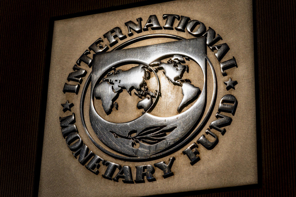 FILE - The logo of the International Monetary Fund is visible on their building, April 5, 2021, in Washington. The IMF is facing pressure to eliminate, or at least, reevaluate how it imposes fees on loans it disperses to needy countries like war-torn Ukraine — which is one of the fund's biggest borrowers. (AP Photo/Andrew Harnik)
