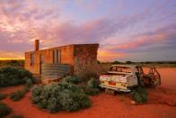 <p>A vintage car sits next to a ruined farmhouse in Silverton, Australia.</p>