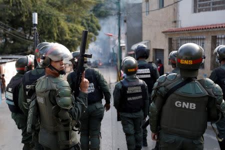 FILE PHOTO: Venezuelan National Guards are seen as demonstrators protest close to one of their outposts in Caracas, Venezuela January 21, 2019. REUTERS/Carlos Garcia Rawlins/File Photo