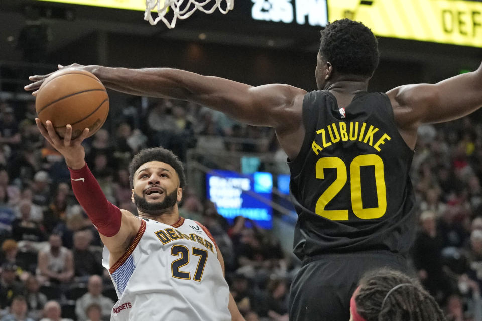 Denver Nuggets guard Jamal Murray (27) goes to the basket as Utah Jazz center Udoka Azubuike (20) defends during the first half of an NBA basketball game Saturday, April 8, 2023, in Salt Lake City. (AP Photo/Rick Bowmer)