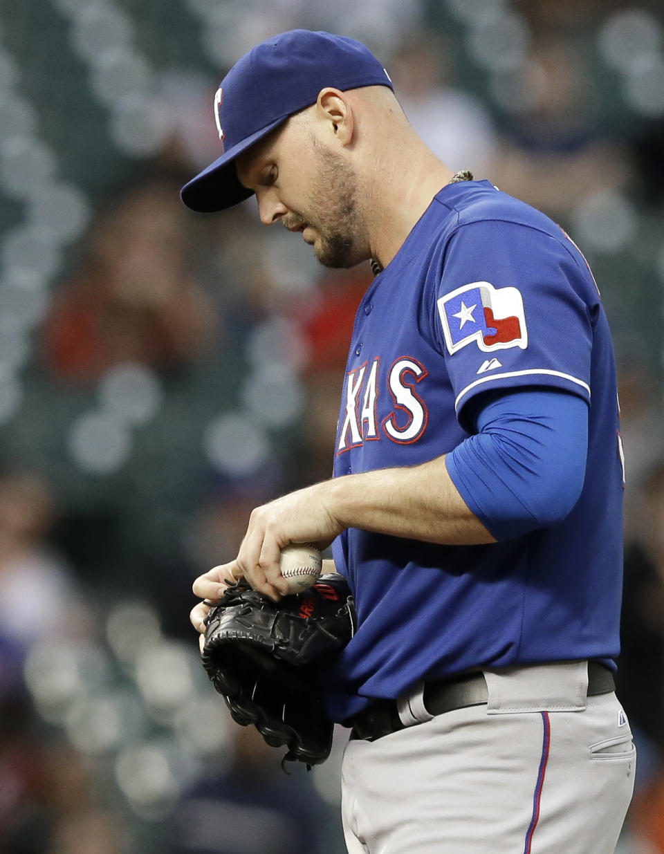 Texas Rangers starting pitcher Matt Harrison takes a moment after giving up an RBI single to Houston Astros' Dexter Fowler in the second inning of a baseball game Tuesday, May 13, 2014, in Houston. Harrison left the game after 1 2/3 innings, giving up four hits and three runs. (AP Photo)