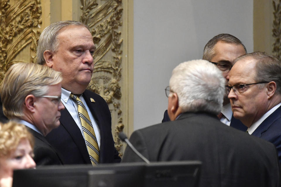 Kentucky State Senator Robert Stivers, rear left, speaks with a group of Senators during a recess of their session at the Kentucky State Capitol in Frankfort, Ky., Thursday, March 16, 2023. (AP Photo/Timothy D. Easley)