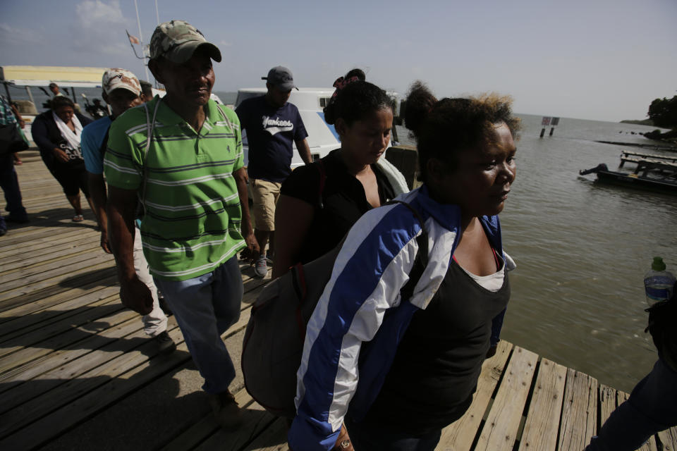 Relatives arrive to identify the bodies of their loved ones, who died in fishing boat that capsized off the Caribbean coast of Honduras, at the Catarasca Naval Base, in Puerto Lempira, Honduras, Thursday, July 4, 2019. The fishing vessel sank during bad weather Wednesday near Cayo Gorda in the Caribbean off Honduras' northern coast. (Jorge Cabrera/Pool via AP)