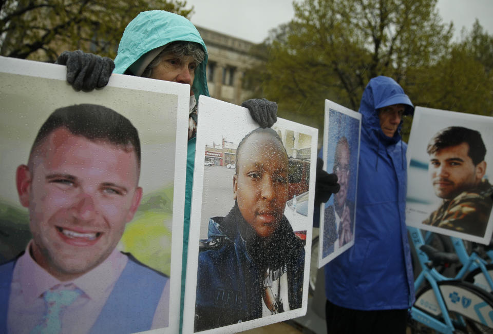 FILE - Protesters hold the photographs of victims, including Melvin Riffel, left, of the Ethiopian Airlines plane crash, outside Boeing's annual shareholders meeting in Chicago on April 29, 2019. Ike Riffel , a California father whose two sons died in the 2019 crash, fears that instead of putting Boeing on trial, the government will offer the company another shot at corporate probation through a legal document called a deferred prosecution agreement, or DPA. (AP Photo/Jim Young, File)