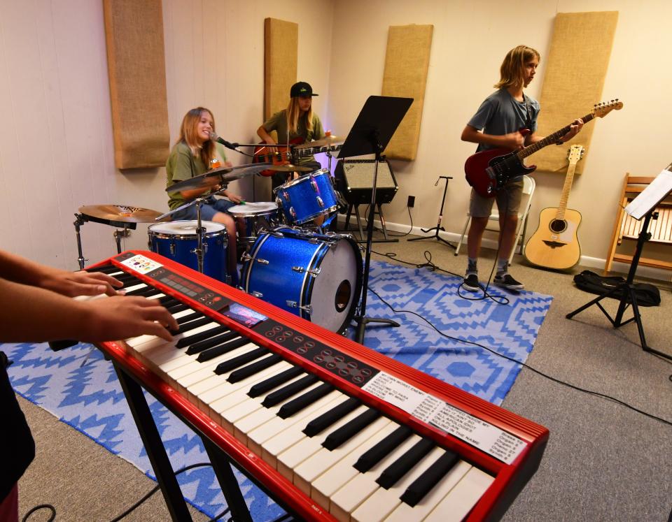 The Tone Deaf Pedestrians rehearse in a band room at The Groove Shack in Satellite Beach.