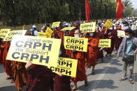 Monks hold signs as they march during an anti-coup protest in Mandalay, Myanmar, Saturday, March 6, 2021. The U.N. special envoy for Myanmar on Friday called for urgent Security Council action, saying about 50 peaceful protesters were killed and scores were injured in the military's worst crackdowns this week. (AP Photo)