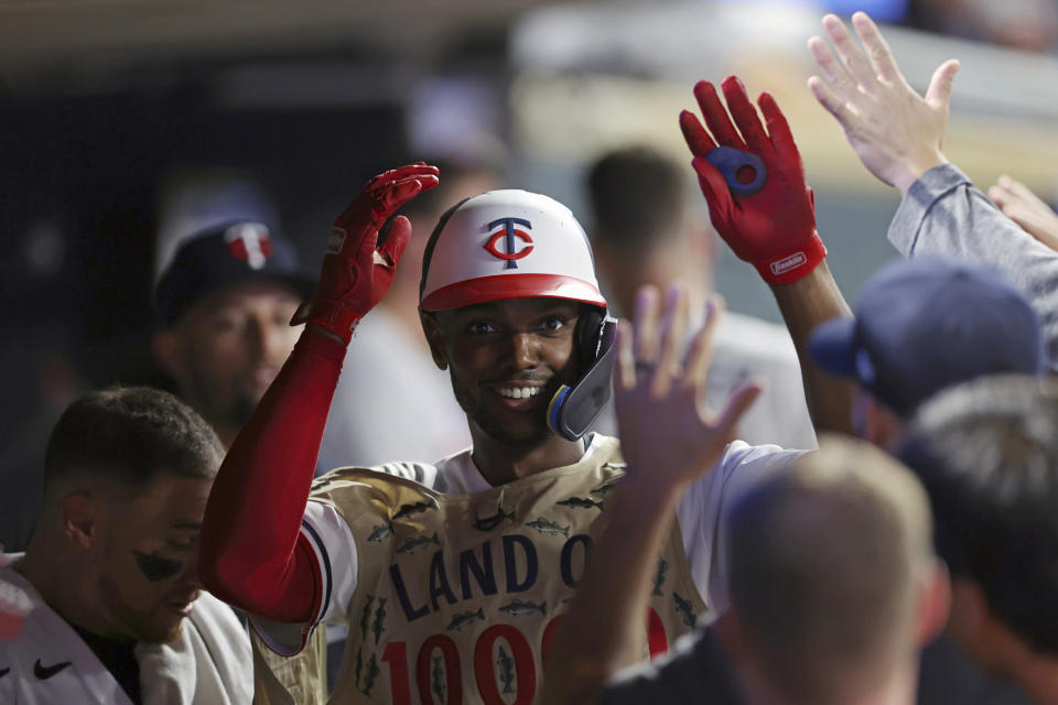 Minnesota Twins' Michael A. Taylor is congratulated in the dugout for his home run against the Arizona Diamondbacks during the seventh inning of a baseball game Friday, Aug. 4, 2023, in Minneapolis. (AP Photo/Stacy Bengs)