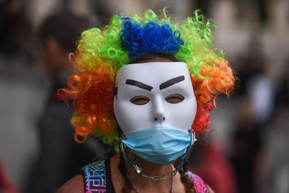 A woman wearing two masks is seen at the 'Unite for Freedom' protest.