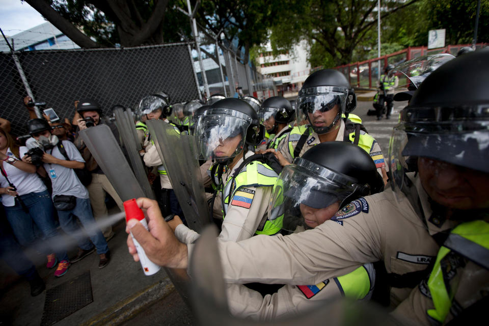 <p>A police officer aims pepper spray at opposition leader Henrique Capriles during a protest in Caracas, June 7, 2016. (AP/Fernando Llano) </p>