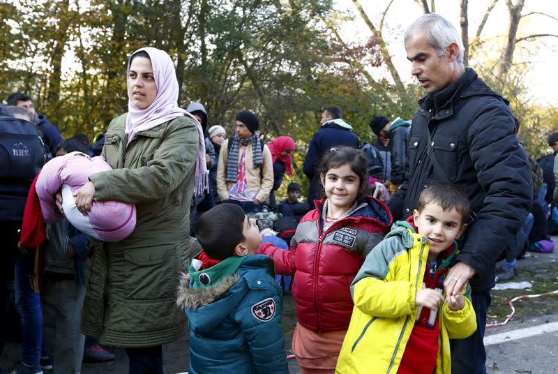 FILE PHOTO: Syrian migrants Khalil arrives with wife and children at the Austrian-German border in Achleiten near Passau