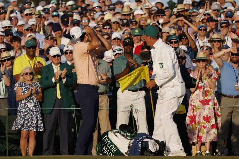 Scottie Scheffler (L) celebrates with his caddie Ted Scott after winning the Masters Tournament on Sunday at Augusta National Golf Club in Augusta, Ga. Photo by John Angelillo/UPI