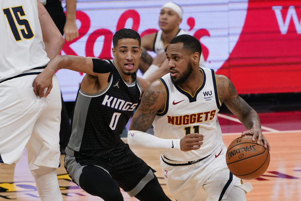 Sacramento Kings guard Tyrese Haliburton, left, goes around a screen as he guards Denver Nuggets guard Monte Morris during the first half of an NBA basketball game in Sacramento, Calif., Saturday, Feb. 6, 2021. (AP Photo/Rich Pedroncelli)