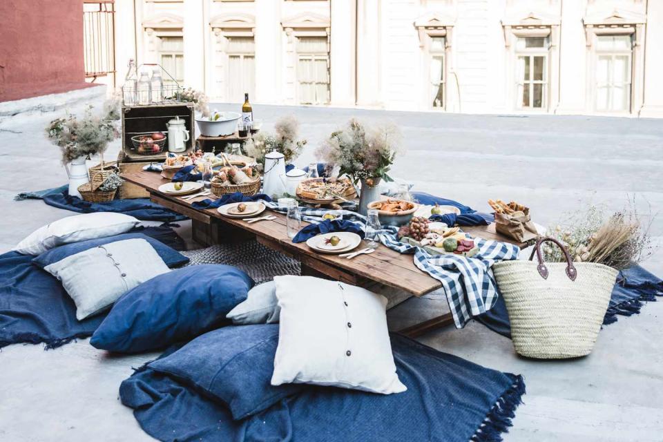 blue pillows and blankets rooftop picnic