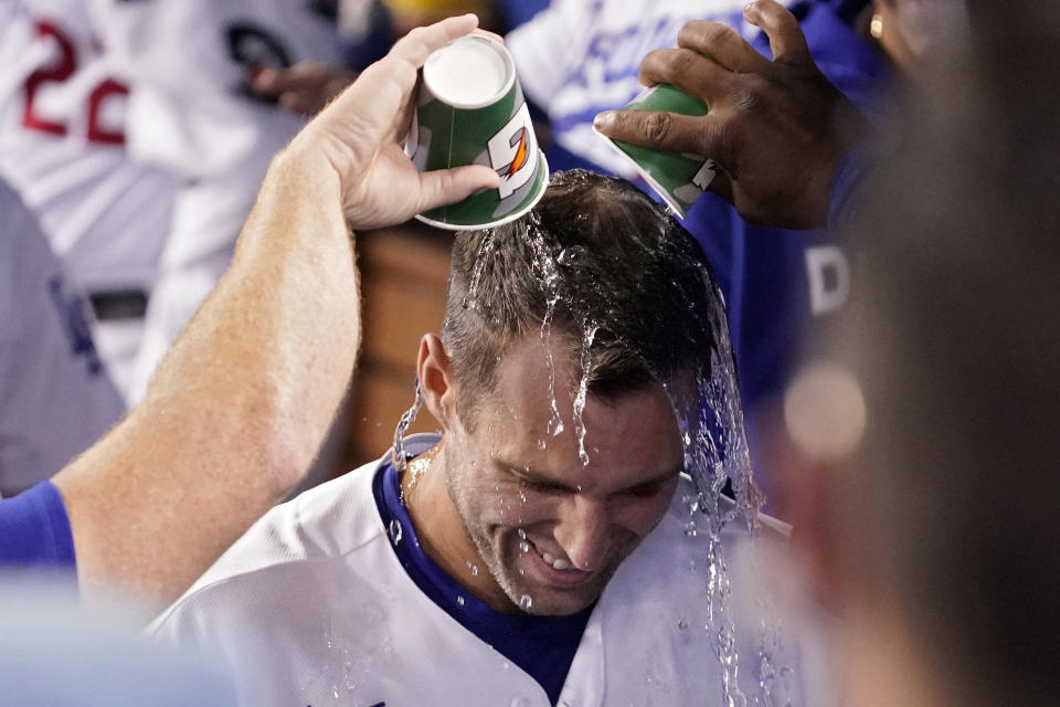 Los Angeles Dodgers' Chris Taylor has water poured over his head by teammates in the dugout after hitting a three-run home run during the fourth inning of a baseball game against the Arizona Diamondbacks Monday, Sept. 19, 2022, in Los Angeles. (AP Photo/Mark J. Terrill)