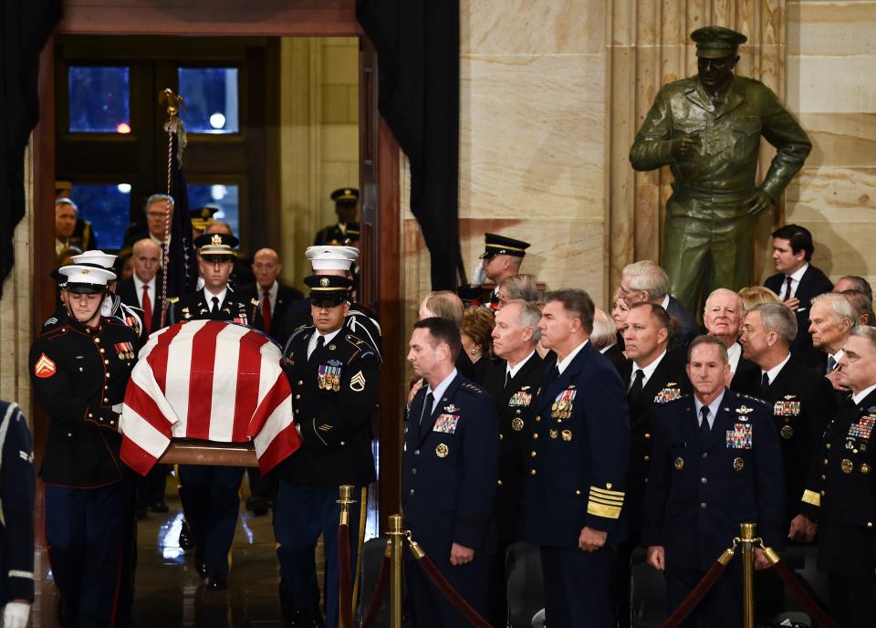 The casket bearing&nbsp;his remains is carried into the Capitol Rotunda.