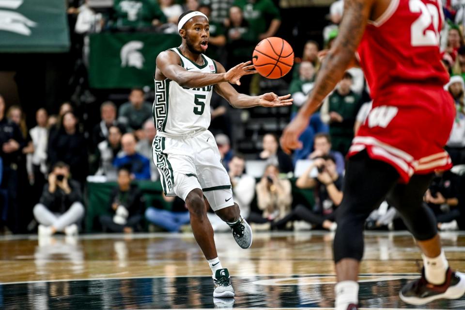 Michigan State's Tre Holloman passes the ball against Wisconsin during the second half on Tuesday, Dec. 5, 2023, at the Breslin Center in East Lansing.