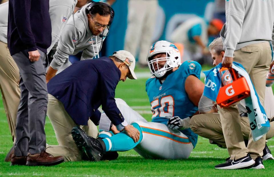 Miami Dolphins guard Connor Williams (58) is treated after being treated during the game against the Tennessee Titans in the first half at Hard Rock Stadium in Miami Gardens, Florida on Monday, December 11, 2023.