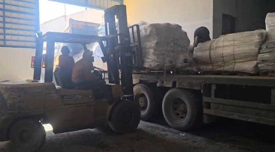 Forklifts unloading tents for Palestinians in Gaza from the Israeli relief group SmartAid.