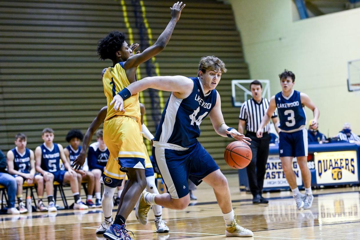 Lakewood's Caleb Hull moves the ball against Eastern's Willie Curtis during a Division 2 boys basketball district. Starting in the 2023-24 school year, Lakewood will be a member of the CAAC. Lakewood is moving to the CAAC after being a member of the GLAC since 2014.