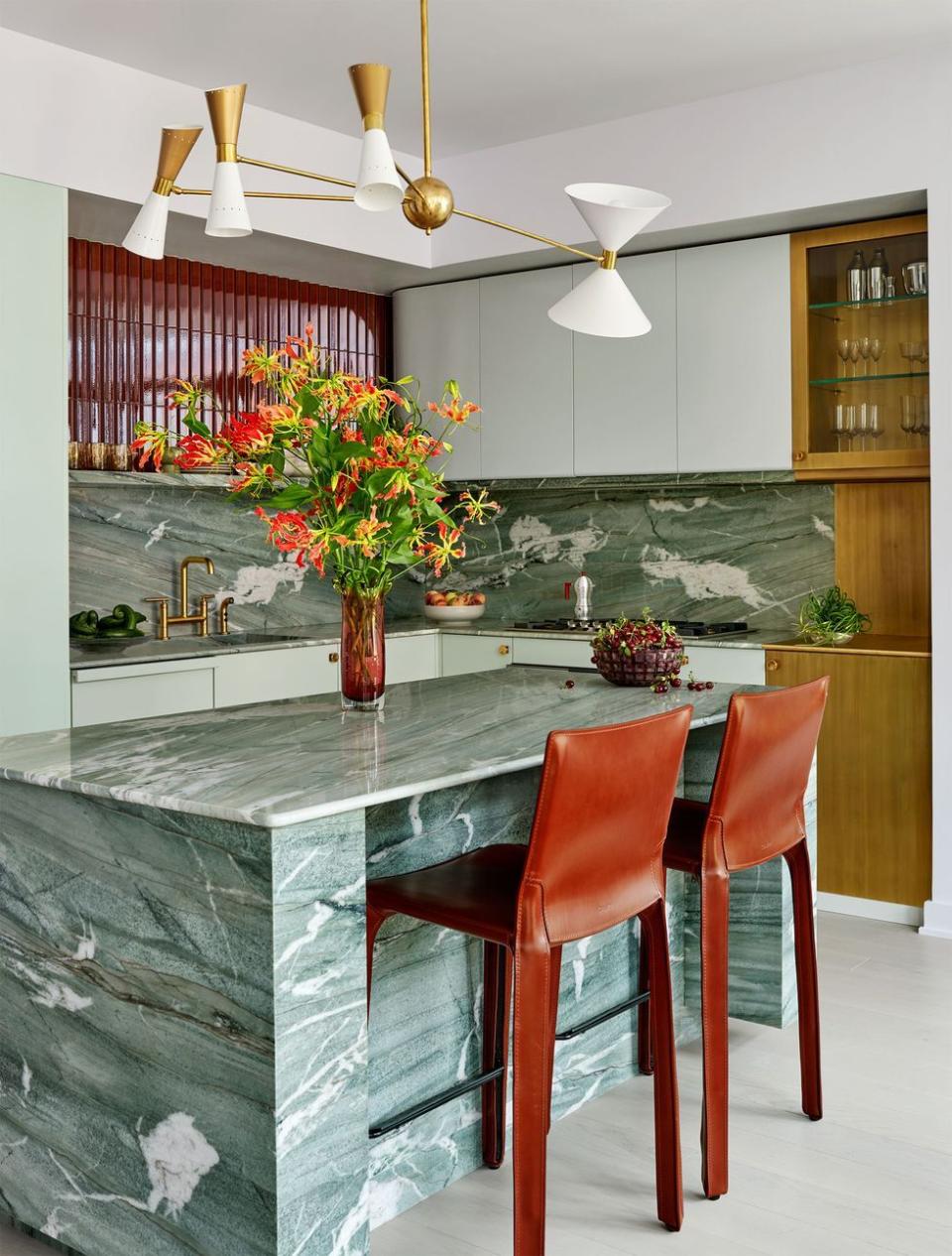 a kitchen with a bar and chairs