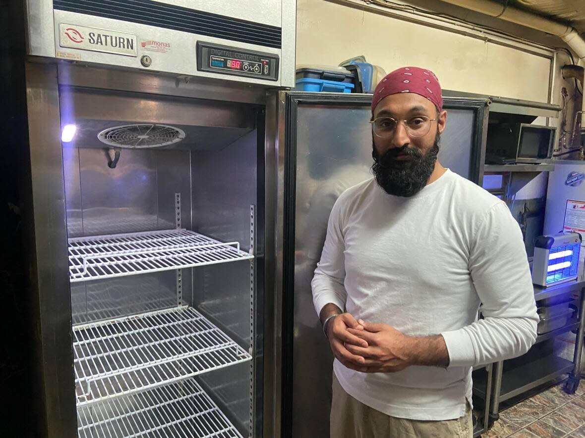 The refrigerators at Darbar restaurant sit uncharacteristically empty after owner Simar Anand says construction outside his restaurant forced him to temporarily shut down nearly three weeks ago.  (Rowan Kennedy/CBC News - image credit)