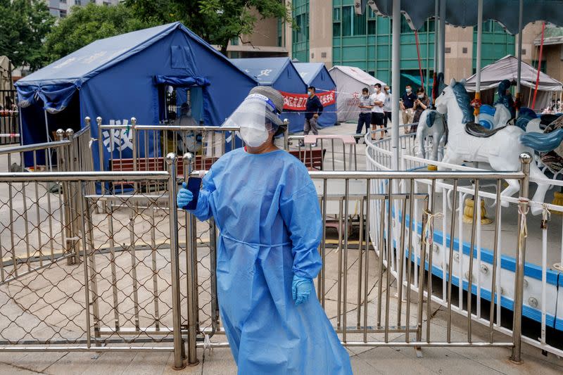 A medical worker in personal protection suit stands at a nucleic acid testing station, following the coronavirus disease (COVID-19) outbreak, in Beijing