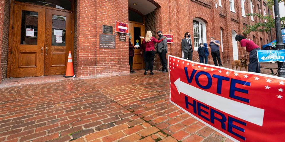 Voters arrive to cast the their ballots on Election Day at City Hall, Tuesday, Nov. 2, 2021, in Alexandria, Va