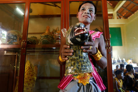 A dancer gets ready before a performance of masked theatre known as Lakhon Khol which was recently listed by UNESCO, the United Nations' cultural agency, as an intangible cultural heritage, along with neighbouring Thailand's version of the dance, known as Khon at the Wat Svay Andet buddhist temple in Kandal province, Cambodia, December 16, 2018. REUTERS/Samrang Pring