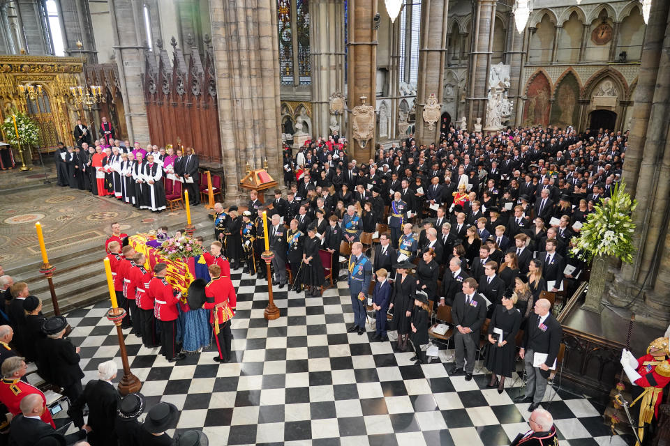 The coffin of Queen Elizabeth II, draped in the Royal Standard with the Imperial State Crown and the Sovereign's Orb and Sceptre, is carried by the Bearer Party the royal family look on (front row) King Charles III, the Queen Consort, the Princess Royal, Vice Admiral Sir Tim Laurence, the Duke of York, the Earl of Wessex, the Countess of Wessex, the Prince of Wales, Prince George, the Princess of Wales, Princess Charlotte, Peter Phillips, Zara Tindall, Mike Tindall, (second row) the Duke of Sussex, the Duchess of Sussex, Princess Beatrice, Edoardo Mapelli Mozzi and Lady Louise Windsor, James, Viscount Severn, Jack Brooksbank, Princess Eugenie, Sarah, Duchess of York, the Earl of Snowdon, Viscount Linley and Lady Margarita Armstrong-Jones (third row) Samuel Chatto, Arthur Chatto, Lady Sarah Chatto, Daniel Chatto, the Duke of Gloucester, the Duke of Kent, the Earl and Countess of St Andrews, Edward Windsor Lord Downpatrick, Lady Amelia Windsor and Lady Marina Windsor during the State Funeral at Westminster Abbey in London. Picture date: Monday September 19, 2022.