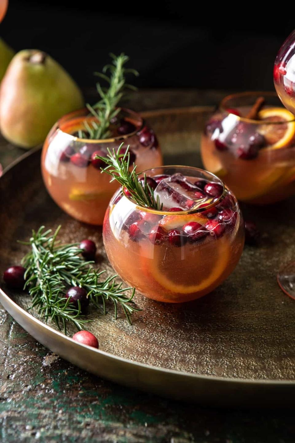 Glasses of pear and cranberry beverage.