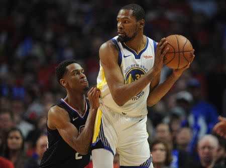 April 21, 2019; Los Angeles, CA, USA; Golden State Warriors forward Kevin Durant (35) controls the ball against Los Angeles Clippers guard Shai Gilgeous-Alexander (2) during the second half in game four of the first round of the 2019 NBA Playoffs at Staples Center. Mandatory Credit: Gary A. Vasquez-USA TODAY Sports