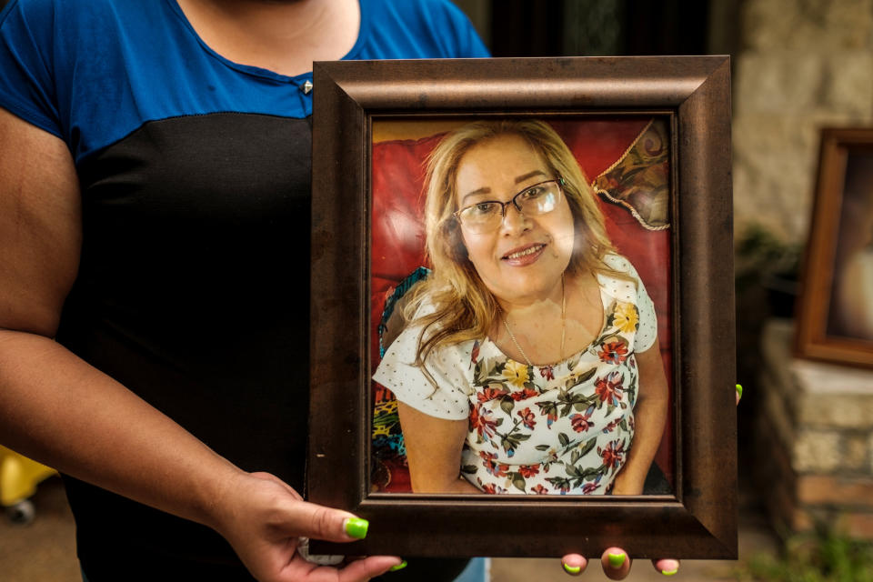 Image: Karen Salazar holds a picture of her mother, Felipa Medell?n, outside of her mother's home in Houston on July 7, 2020. (Fred Agho / for NBC News)
