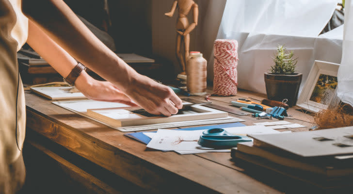 Image of a person doing crafts on a table.